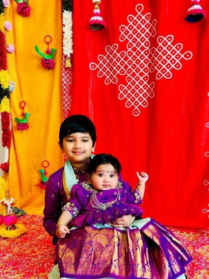 Seeing my creations bring families together is the best feeling. These adorable siblings are twinning in custom purple Kanchi pattu outfits, with the brother in a smart kurta-dhoti and his baby sister in a matching pattu pavadai.