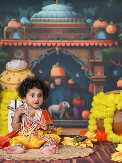 A slightly different angle of the Krishna setup, showing the intricate backdrop and the arrangement of props around the baby.