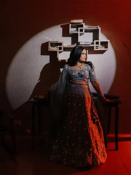 A solo portrait of the bride at her reception, illuminated by a single spotlight, creating a classic, elegant look.