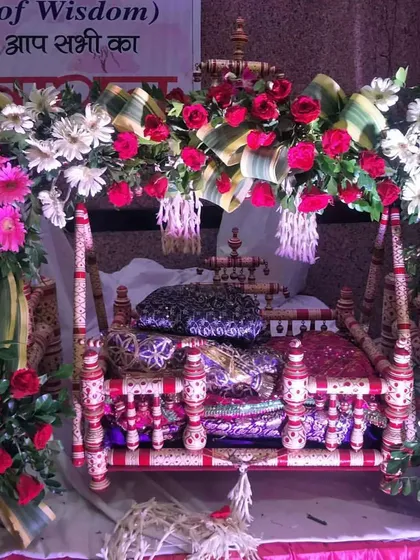 An identical view of the lovely jhula for Ladoo Gopal, showcasing the fresh pink roses and white gerberas used for the Janmashtami pooja.