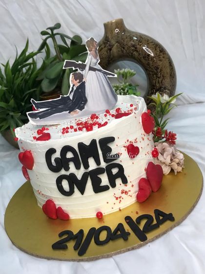 Who says bachelorette cakes can't be elegant and funny? This 'Game Over' cake was so much fun to create, featuring a humorous topper, the wedding date, and red heart details.