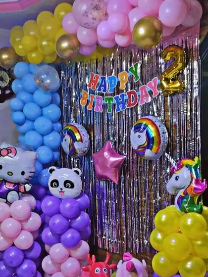 This colorful setup combines multiple kid-favorite themes, including Unicorn, Hello Kitty, and Panda. The decoration features a silver tinsel backdrop, character foil balloons, and bright balloon columns, perfect for a fun and varied birthday party.