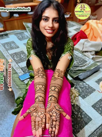 A happy bride showcasing her full bridal mehndi. The design is a beautiful mix of traditional patterns and personalized elements, and her smile says everything about her satisfaction with our work.