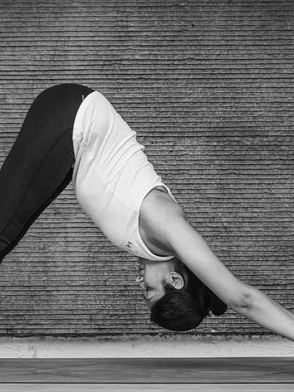 Placing blocks under the hands in Adho Mukha Svanasana, or Downward-Facing Dog, can make the pose more accessible if you have tight shoulders or hamstrings. It helps to lengthen the spine and reduce pressure on the wrists.