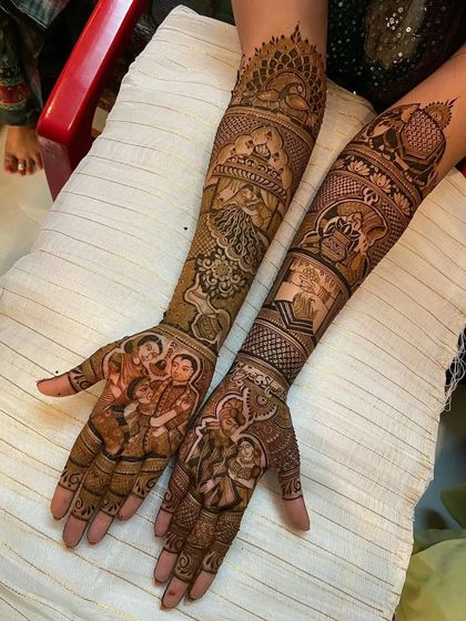 A tribute to parents, this design features family portraits on the palms, with a mountain scene and other personal elements on the forearms.