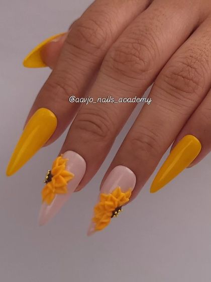 Another angle of the 3D sunflower nails. The stiletto shape adds drama, while the combination of solid yellow and detailed floral art creates a balanced and eye-catching design.