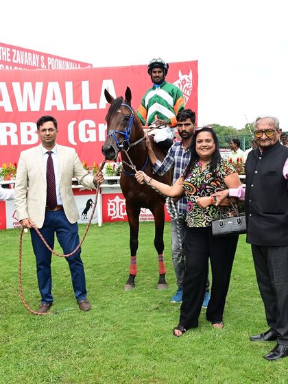 Thundering Phoenix, with jockey Antony Raj.S, poses with the winning team.