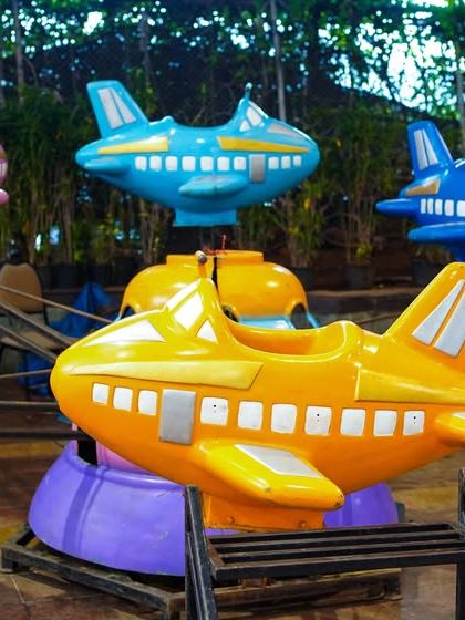 A vibrant, multi-colored airplane carousel ride where little pilots can choose their favorite plane and enjoy a gentle spin.