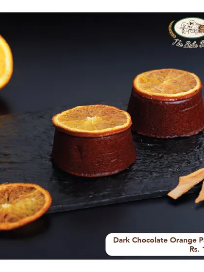 The Dark Chocolate Orange Pastry is a zesty and rich individual dessert, topped with a slice of candied orange.