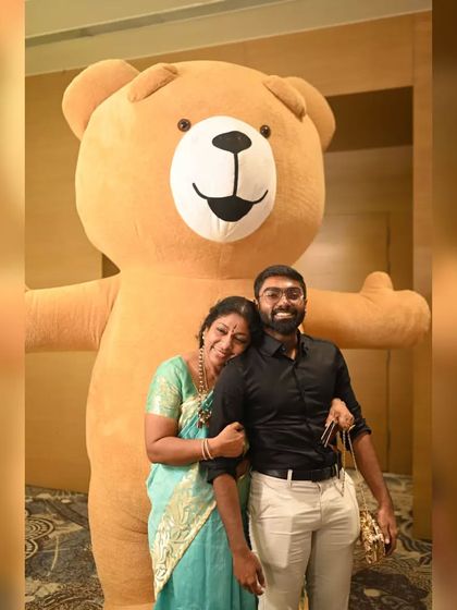 Our giant brown Teddy Bear gives the warmest hugs, making it a perfect addition to weddings and family functions. Here it is creating a sweet moment with guests.