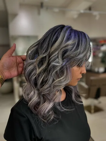 A side view of the 'Winter Frost' look. You can see how the purple is subtly woven into the cool ash tones for a modern and edgy style. This is a bleach color.