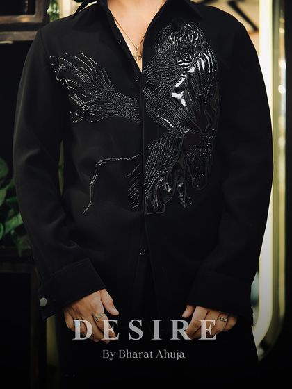 From the first drink to the final song, this black designer shirt carries class, charm, and just enough edge to keep the party watching.
