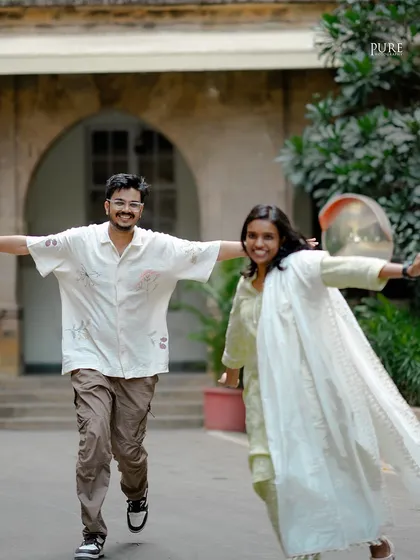 Sometimes the best moments are the unscripted ones. This joyful, candid shot of Anusha and Nikit running outside their old college captures the pure happiness and carefree spirit of their relationship.