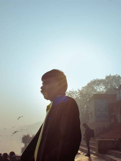 Using the bright morning sun to create a silhouette, this shot focuses on the form and atmosphere rather than detail. It's an artistic way to capture a person within their environment.