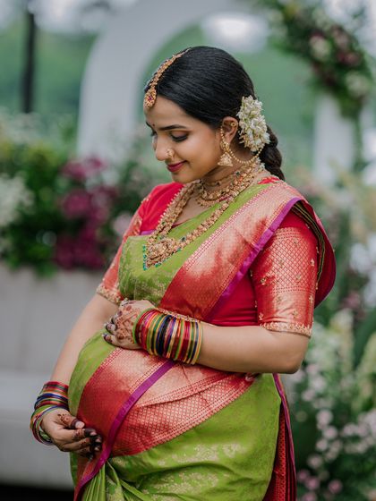 A close-up of the Valaikappu look. The traditional jewelry and perfect drape come together to create a look of timeless beauty.