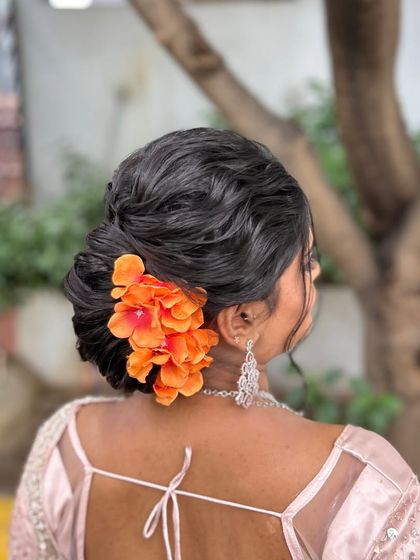 A side view of the floral textured bun, a beautiful choice for a daytime event.