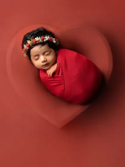 All our love, wrapped in one tiny package. This simple yet powerful shot places a swaddled newborn inside a heart-shaped bowl, symbolizing the immense love that surrounds a new baby.