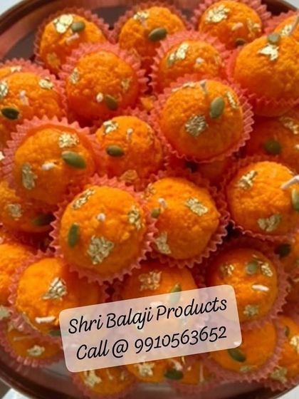 A tray full of freshly made Boondi Ladoo candles, garnished with pumpkin seeds and gold foil. This shows the beautiful, consistent results you can achieve with my ladoo molds and soy wax.