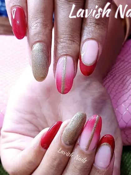 A striking combination of red, pink ombre, and gold glitter nails, tied together with a fine gold stripe.