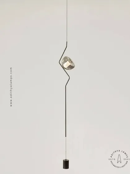 A masterclass in minimalist sophistication, this unique ceiling-to-floor light installation features a slender rod with a single, jewel-like light source. It creates a continuous visual line that adds a futuristic and elegant touch to any modern space.