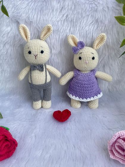 A lovely bunny couple, with the girl in a purple dress and the boy in smart grey trousers and a bow tie. They make a perfect wedding or anniversary gift.