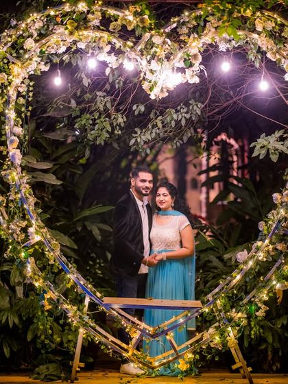 The heart-shaped light prop provides a perfect frame for this happy couple's pre-wedding photo.