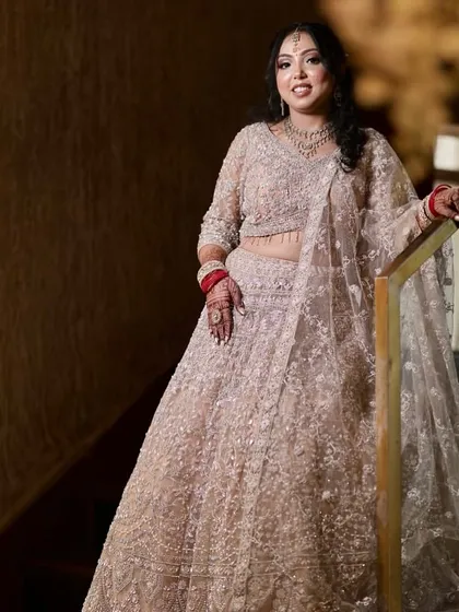 A full-length view of this elegant engagement style. The makeup and hair are perfectly balanced with the heavily embroidered lehenga.