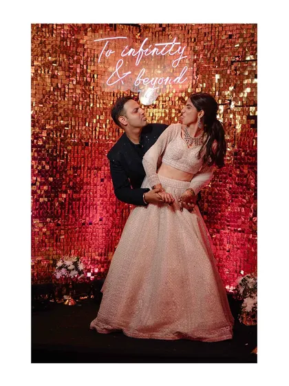 A playful, candid moment of the couple enjoying their party. Their genuine laughter is infectious.