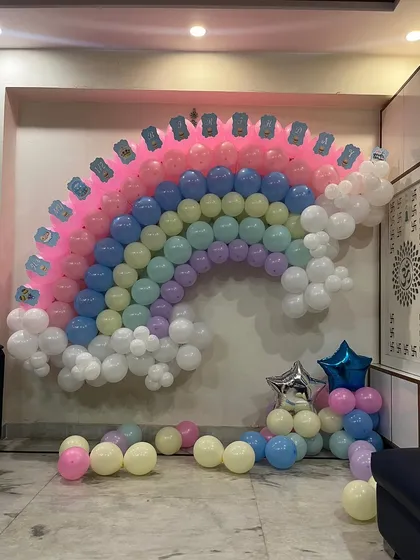 A close-up of the intricate work involved in creating a multi-colored balloon wall.