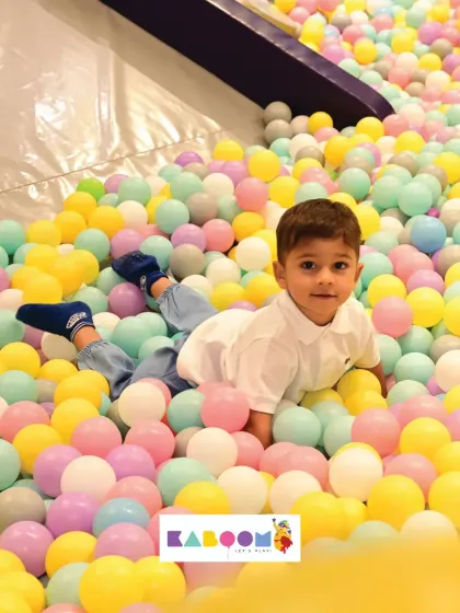 Just relaxing in a sea of color. Our ball pit is a soft and safe place for even the littlest ones to explore.