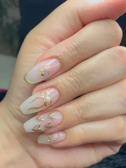 A close-up of the delicate gold chrome hearts and bows.