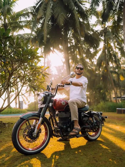 A morning shot with a custom Royal Enfield, bathed in the soft Goan sunlight. The focus here is on the relaxed, adventurous lifestyle associated with the brand, making the product feel like a natural part of the scenery.