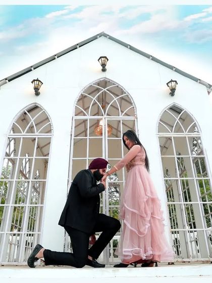 A fairytale proposal moment during a pre-wedding shoot. The grand white architecture and the classic pose make this a timeless and incredibly romantic photograph.
