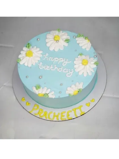 A simple and sweet daisy cake for Pracheeti's birthday. This chocolate vanilla cake is decorated with hand-piped daisies for a fresh and charming look.