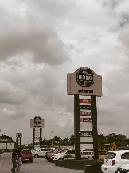 A wide shot of our parking lot and sign pylons on a cloudy day, showing the scale of our facility.
