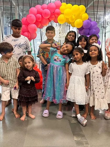 A group of kids posing for a photo after a fun party. We love seeing these big smiles at the end of a celebration.