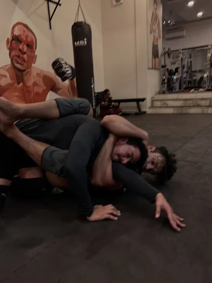 Caught in a tough spot, this grappler works to defend a choke while his opponent maintains tight control. This is where mental toughness is built.