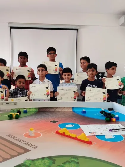 A proud group of students holding up their certificates after successfully completing a program at our North Bangalore center.