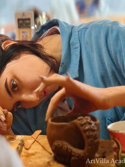 Intense focus during our ceramic hand-building workshop at Doolally Taproom. This participant is meticulously crafting an octopus-themed mug, showcasing incredible attention to detail.