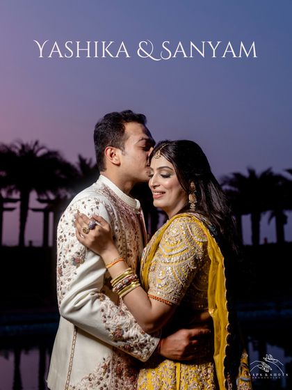 The official couple portrait for Yashika and Sanyam. Their complementary outfits, her in Nidhi Tholia and him in Jatin Malik, look absolutely perfect against the dusky sky.