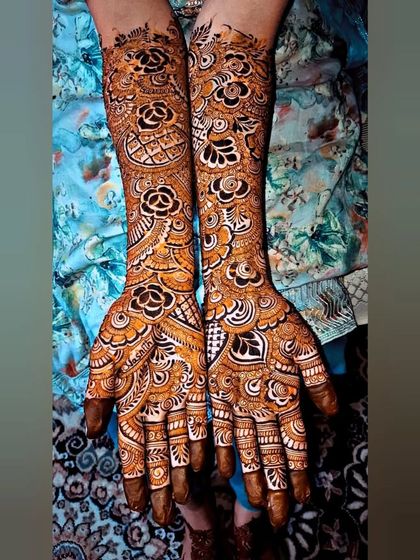 Another angle of this intricate bridal design, showcasing the beautiful floral work on the forearms. The combination of roses and traditional patterns is timeless.