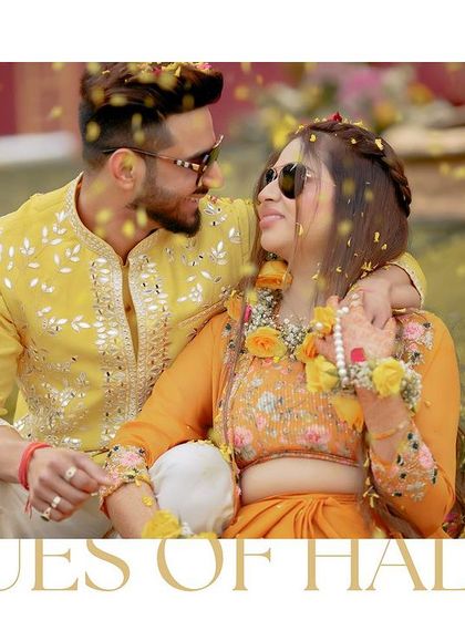 A candid, romantic moment between Akhilesh and Nisha, seated together, their smiles and sunglasses reflecting the happy, sunny vibe of the day.