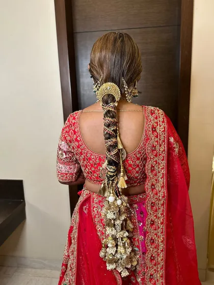A stunning, heavily accessorized braid for the wedding day. This is a true statement hairstyle, perfect for a bride who wants a look of royal grandeur.