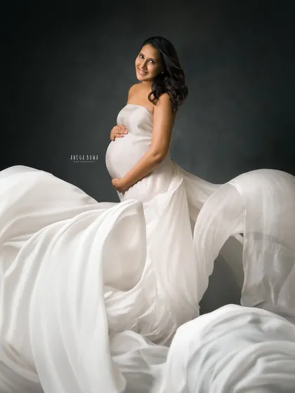 This is the magic I want every mother-to-be to feel. A moment of pure strength and elegance, captured in my studio with dramatic lighting and a flowing gown from my collection. This is your time to feel like a goddess.