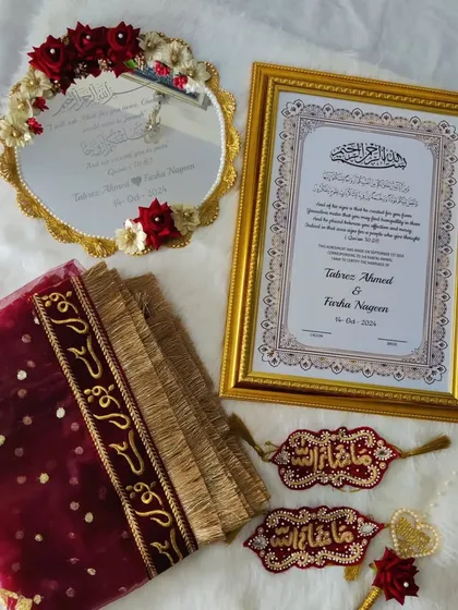 This is one of my complete Nikah sets, and it’s one of my babies. It includes a personalized framed Nikah Nama, a 'Muah Dekhaye' mirror, a 'Qubool Hai' dupatta, and beautifully detailed 'Masha-Allah' hangings. Everything is coordinated in rich maroon and gold to bring a royal touch to your ceremony.