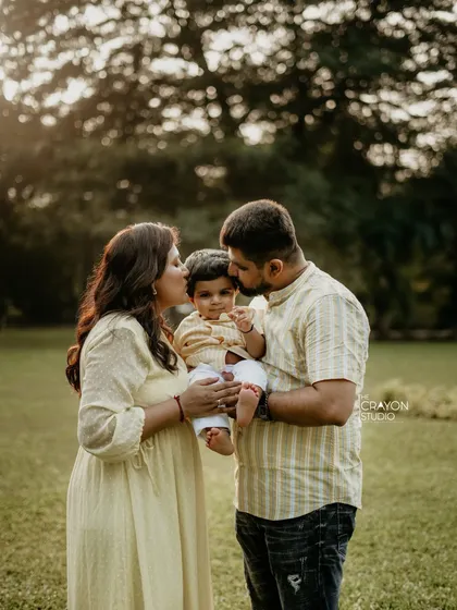 In a beautiful outdoor setting, I capture the unposed kisses and gentle embraces that define your family's love story. This is the warmth and connection that makes a family portrait timeless.