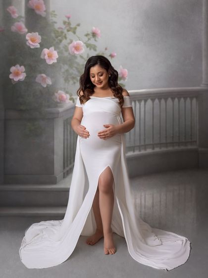 An angelic solo portrait in a classic white gown. The digitally added floral elements and soft lighting create a timeless, fine-art feel.