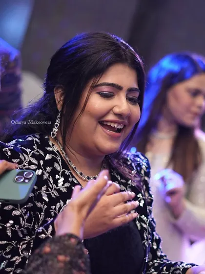 A candid shot capturing the bride's happy moments during her engagement party. The makeup is glamorous yet feels light, allowing her to enjoy her night to the fullest.