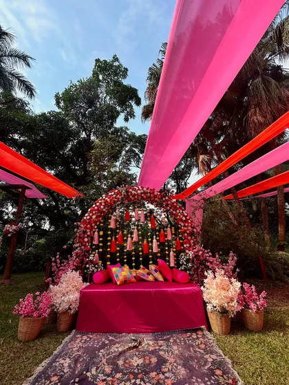 The same Mehendi setup viewed from a different angle, showing how the overhead drapes create a beautiful canopy. I design spaces that look stunning from every perspective.