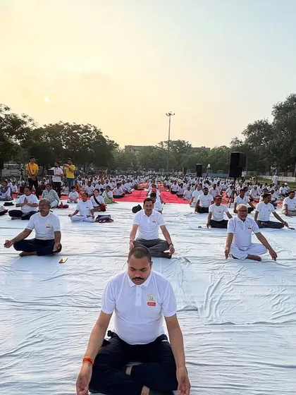 A wide view of a mass meditation session. The collective energy of hundreds of people meditating together creates a powerful field of peace and stillness that benefits everyone present.